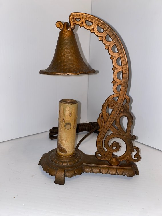 Vintage cast iron bridged arm accent lamp with ornate scrolled arm and a textured bell shade