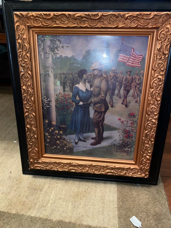 Black and gold framed WWI picture with image of soldier and lady