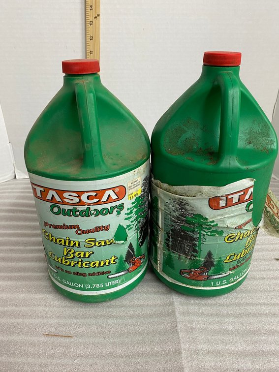 1 Gallon jug of bar and chain oil, 1 partial jug