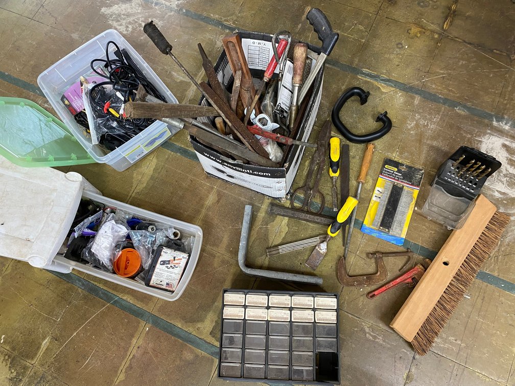 Tools, drill bits, c-clamp, tin snips, small plastic parts bin, wires, files