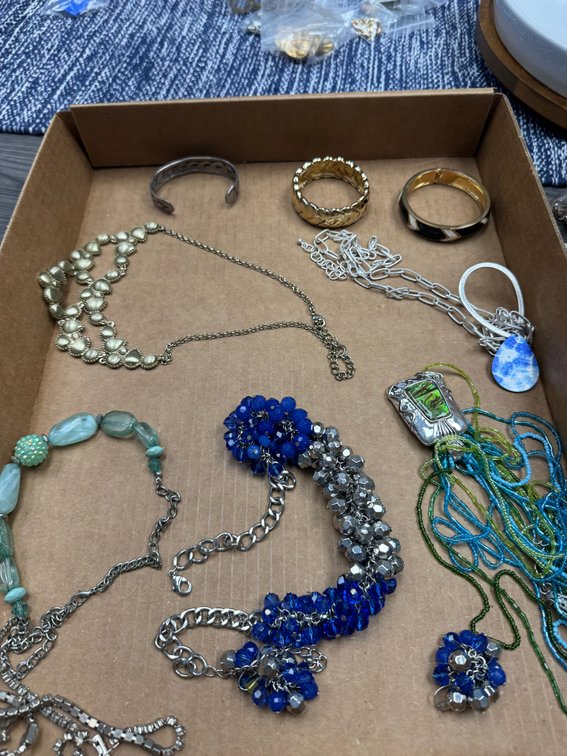 Variety of metal bracelets, beaded necklaces