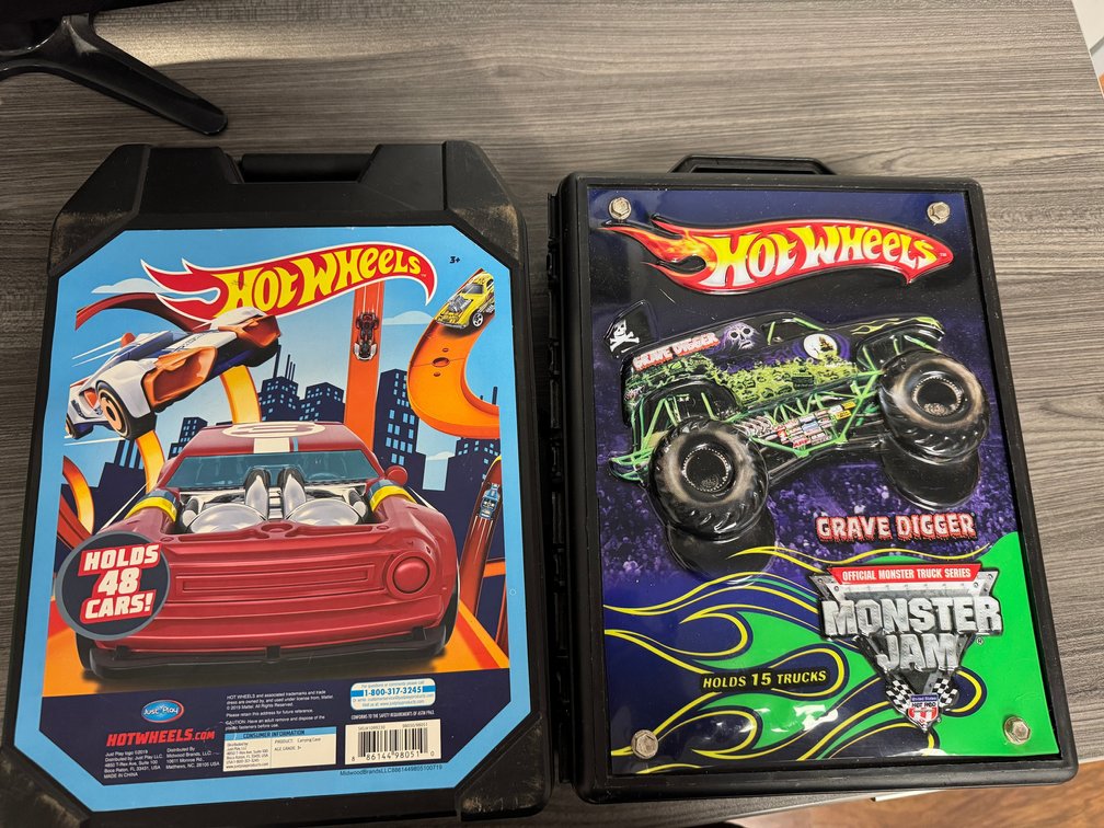 Black Hot Wheels car storage cases with cars