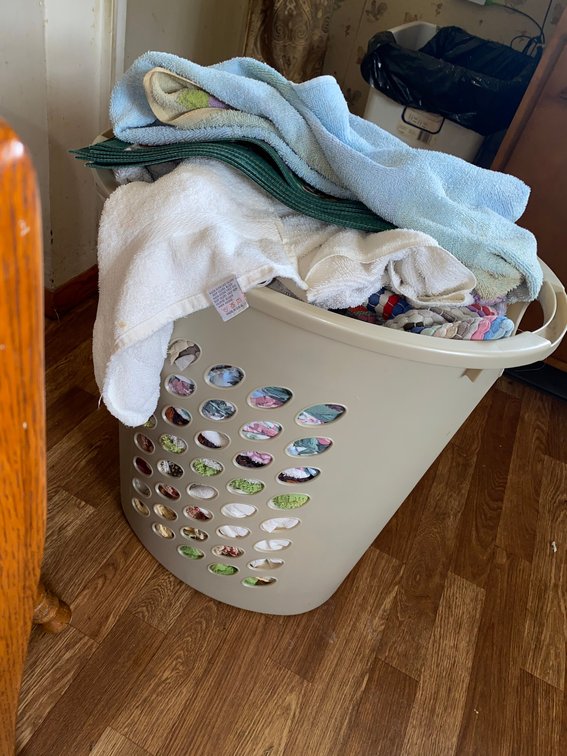 Laundry basket with towels, sheets, misc. dry goods