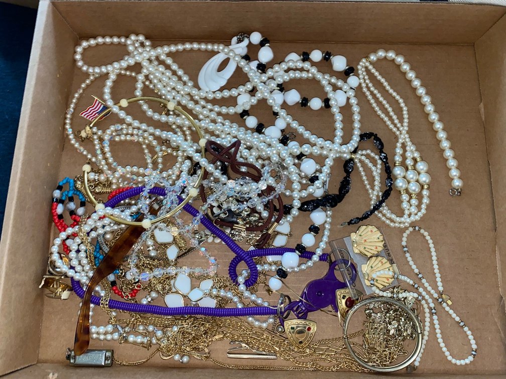 Flat of costume jewelry