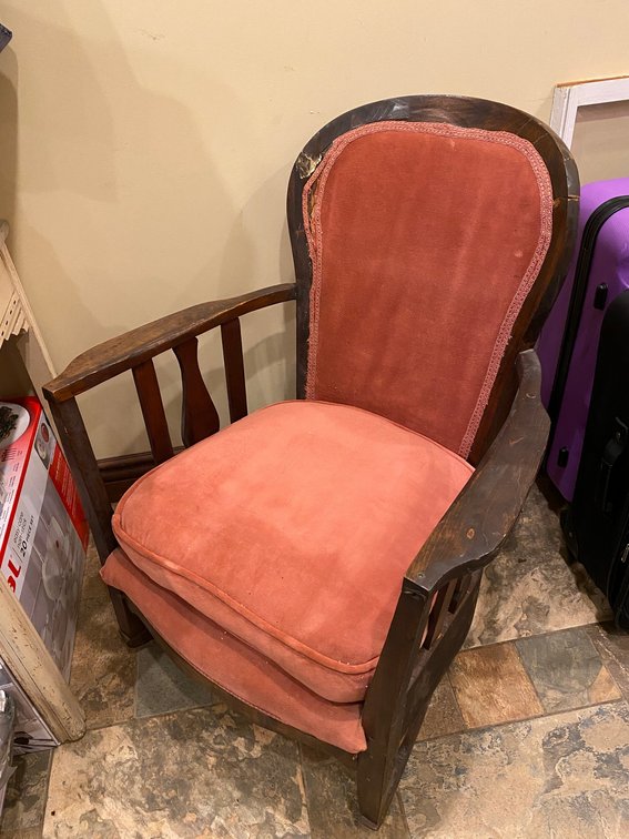 Wooden antique rocking chair with upholstered cushions