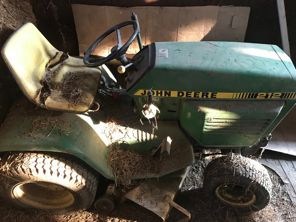 John Deere 212 riding mower with deck on it