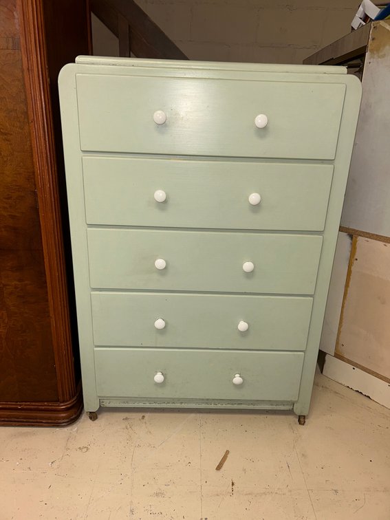 Light-green painted five-drawer tall chest with simple round white knobs