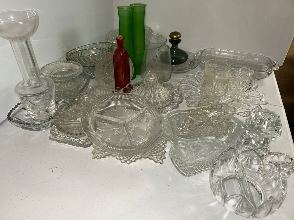 Clear pressed-glass items and two green vases