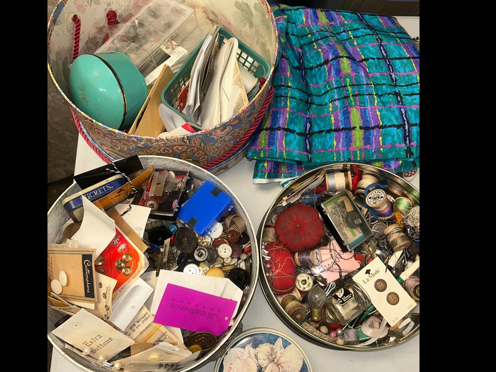 Sewing boxes with thread, buttons, and some fabric