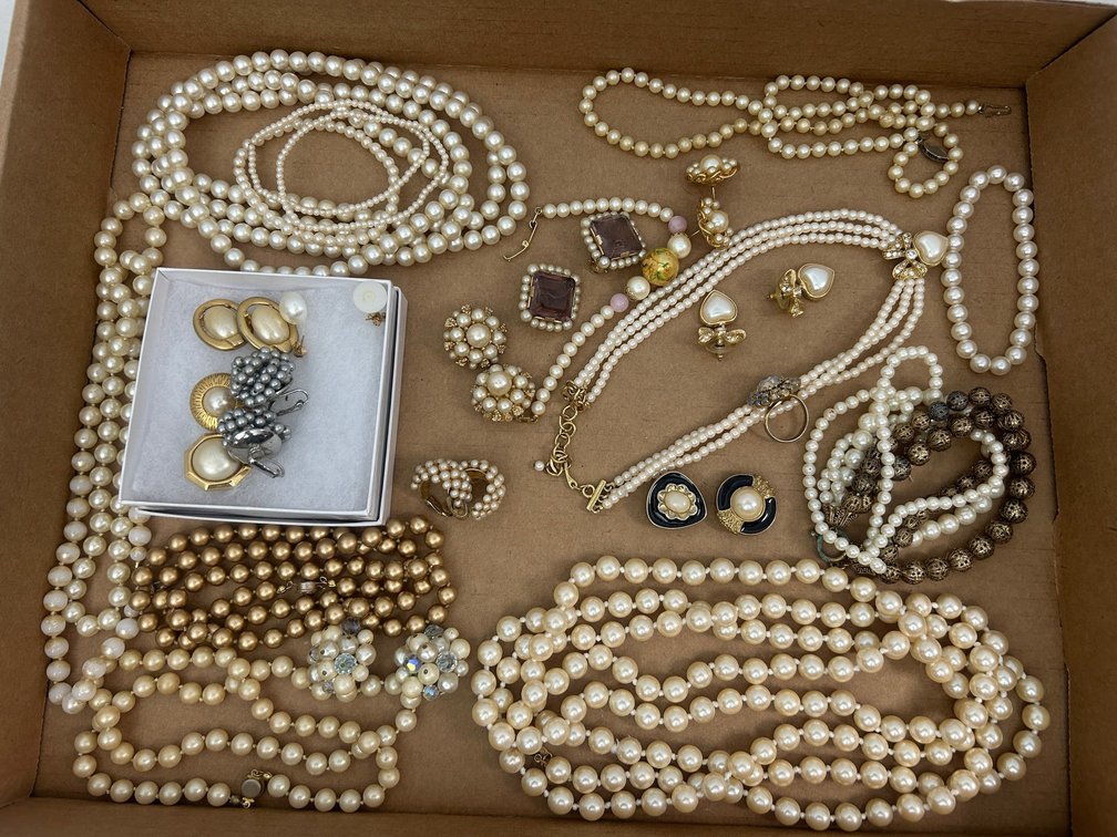 Ladies' costume jewelry including faux-pearl necklaces and earrings