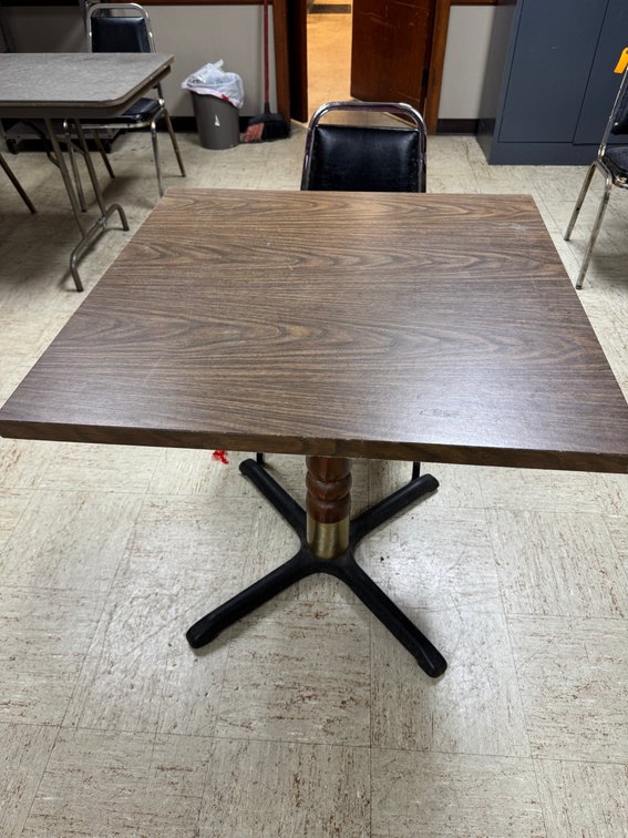 Rectangular banquet tables with black chairs