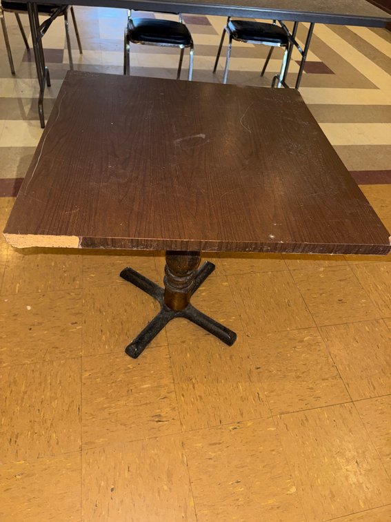 Square banquet tables with black chairs
