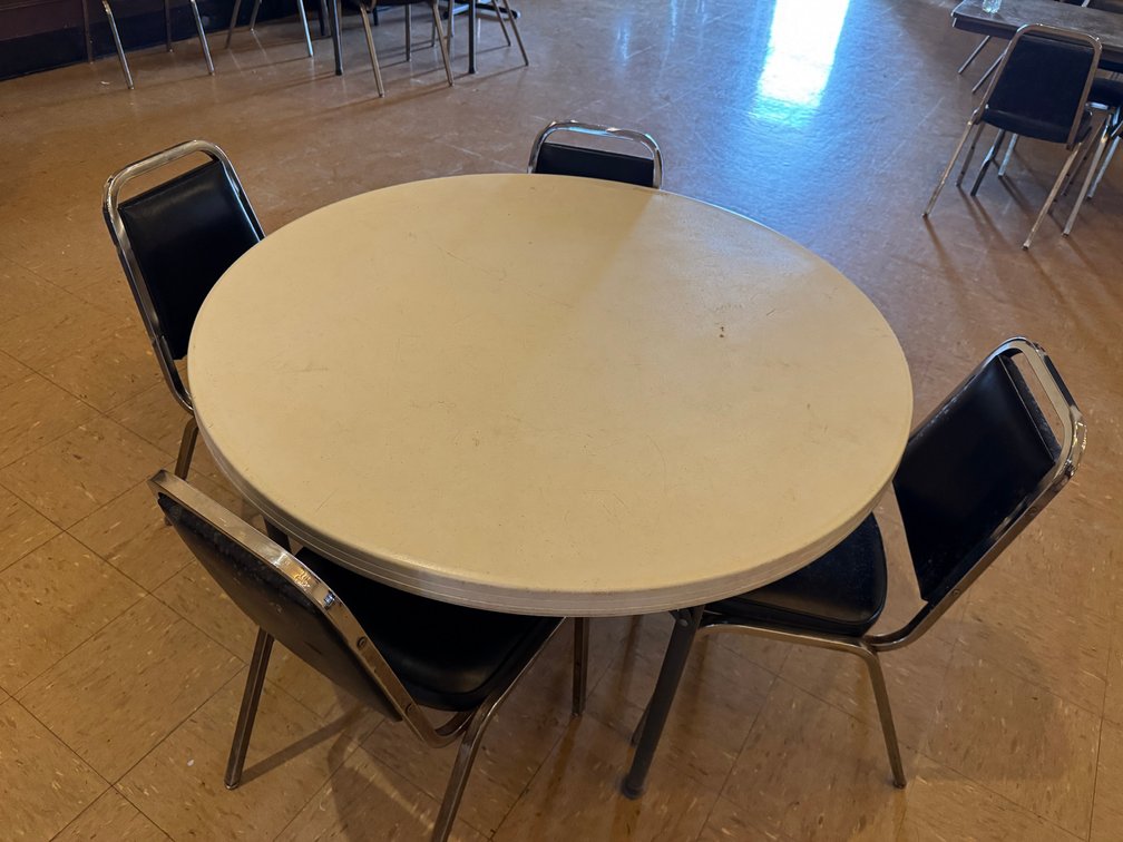 Round banquet tables with black chairs