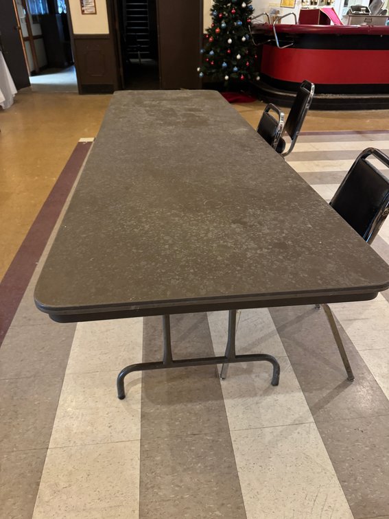 Rectangular banquet tables with black chairs