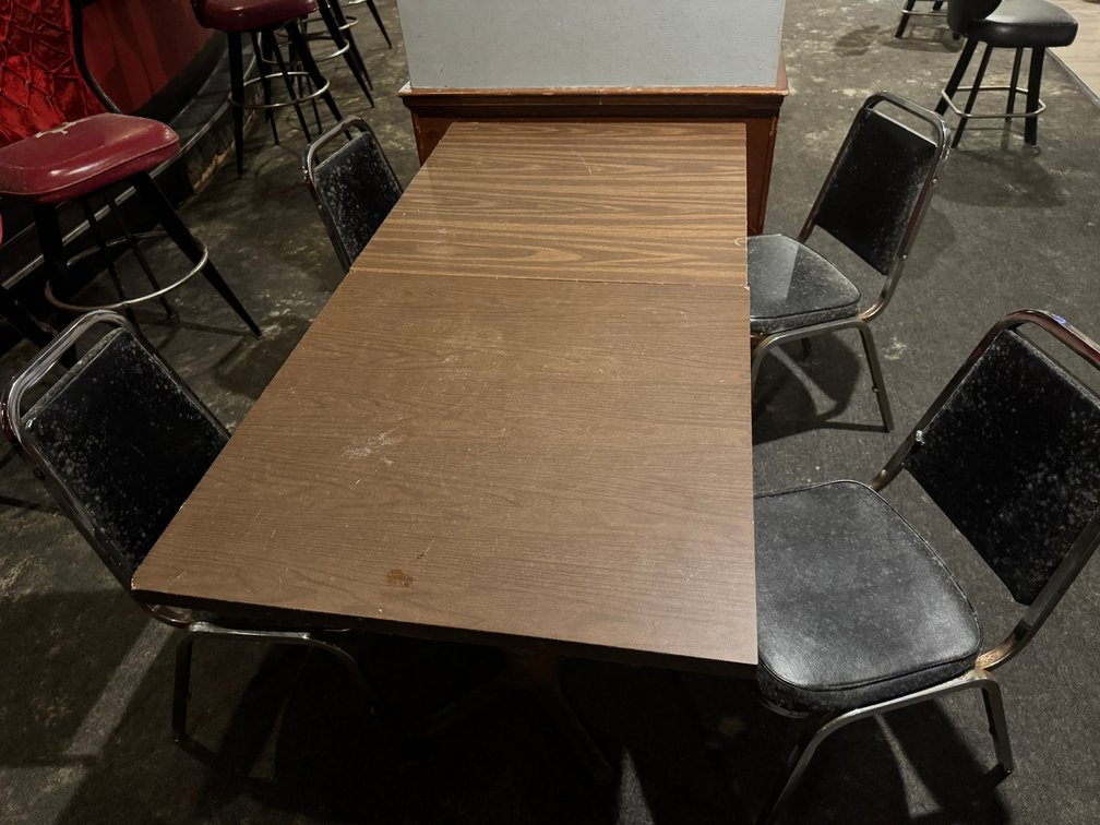 Rectangular banquet tables with black chairs