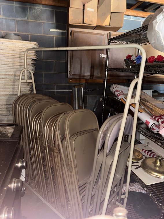 Beige Padded Folding Chairs on Rack