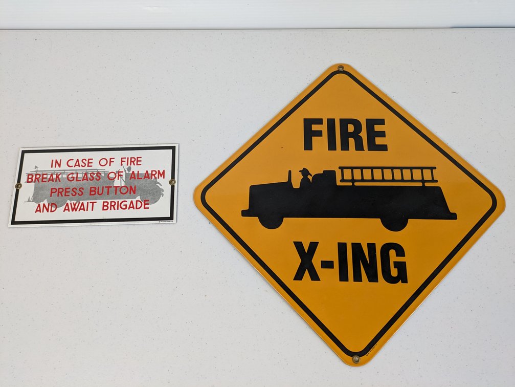 Two Ande Rooney Porcelain Signs