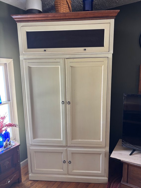 Ethan Allen Cabinet with Crown Molding and a dark-accented top pane