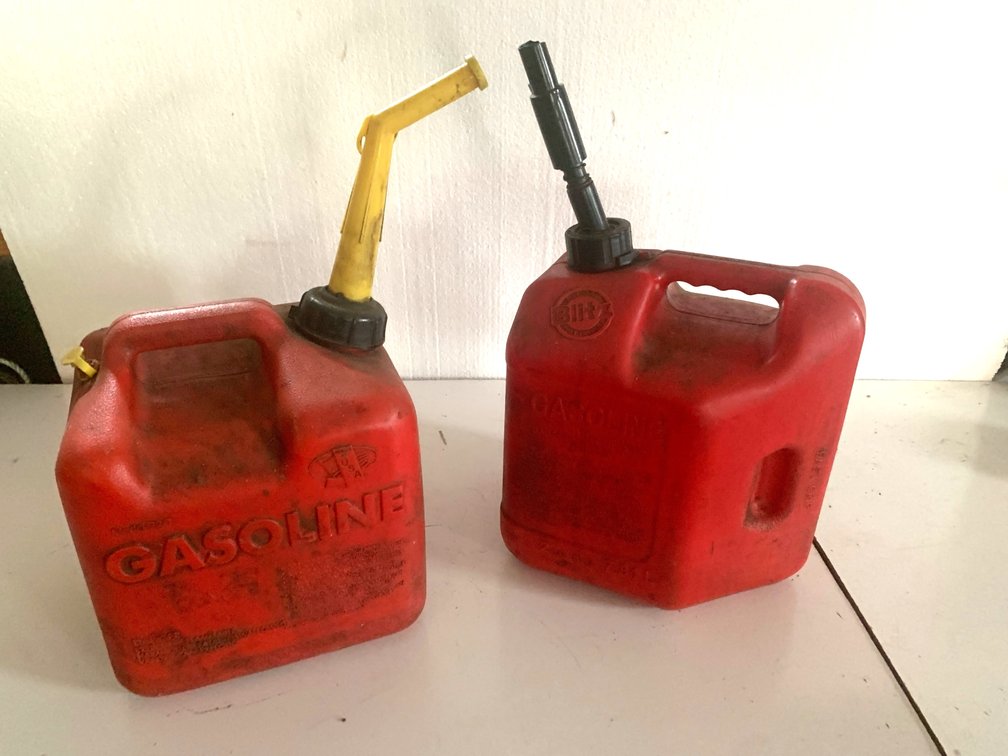 Two Red Plastic Gasoline Cans