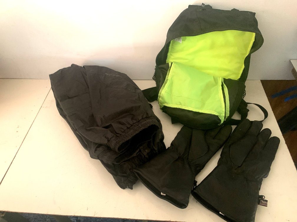 Outdoor Apparel and Gear Lot with Backpack, Pants, and Gauntlet Gloves
