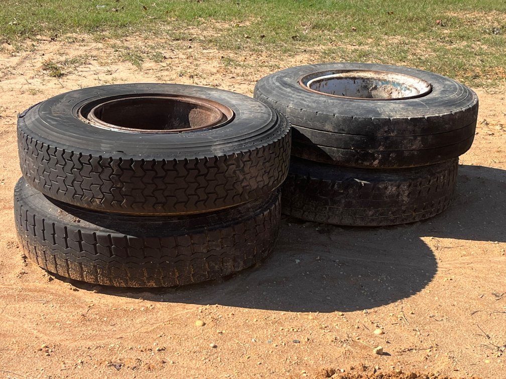 Four 10.00R20 Tires Mounted on Open-Center Steel Rims
