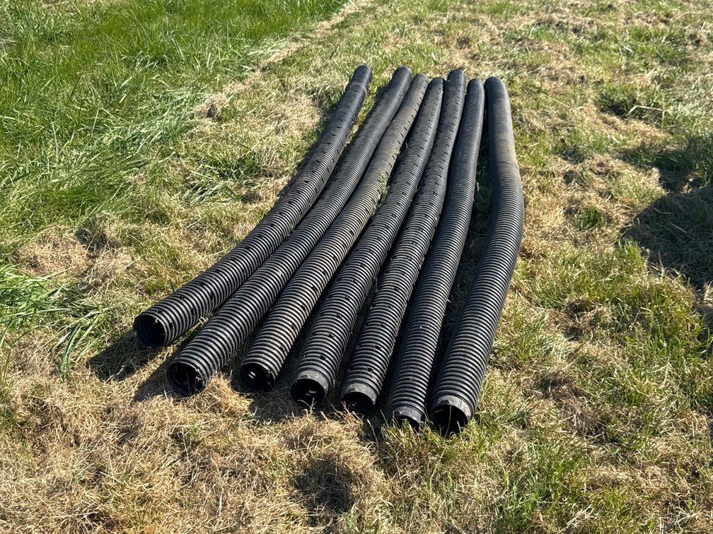 Seven Black Corrugated Plastic Drainage Pipes