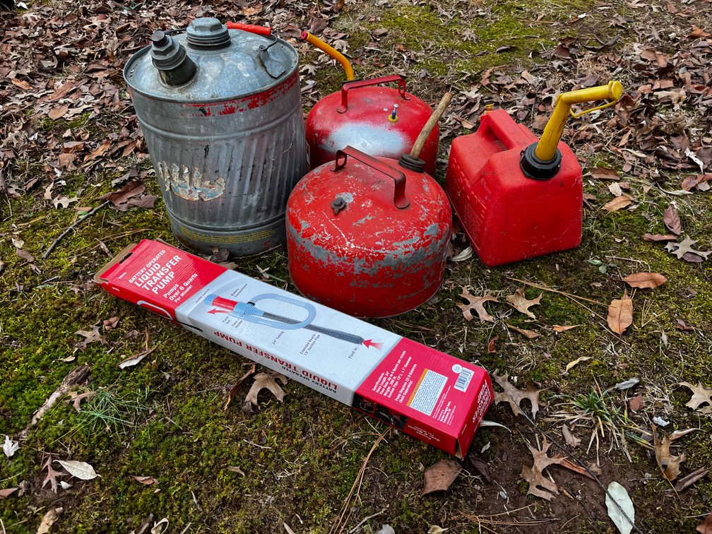 Four Gas Cans and Transfer Pump