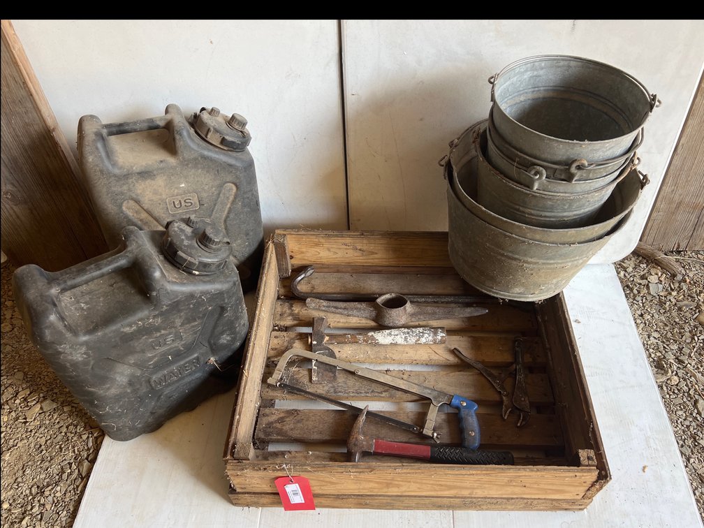 Assorted tools, buckets and Water jugs in a wooden crate