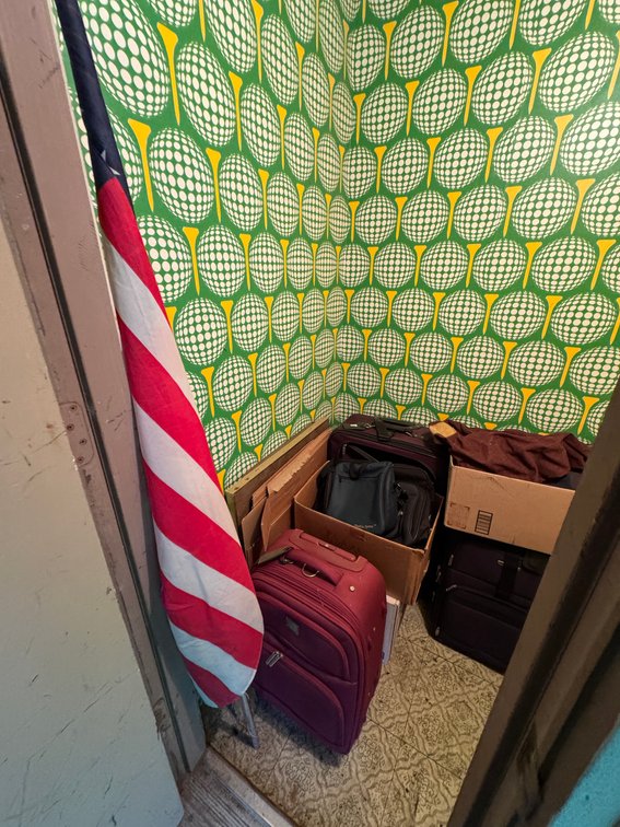 Contents of outdoor closet, American Flag, luggage
