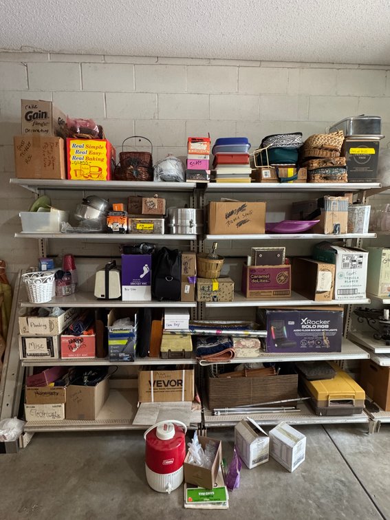 Contents of southeast garage shelves, décor, frames, tupperware, whicker, coleman jug