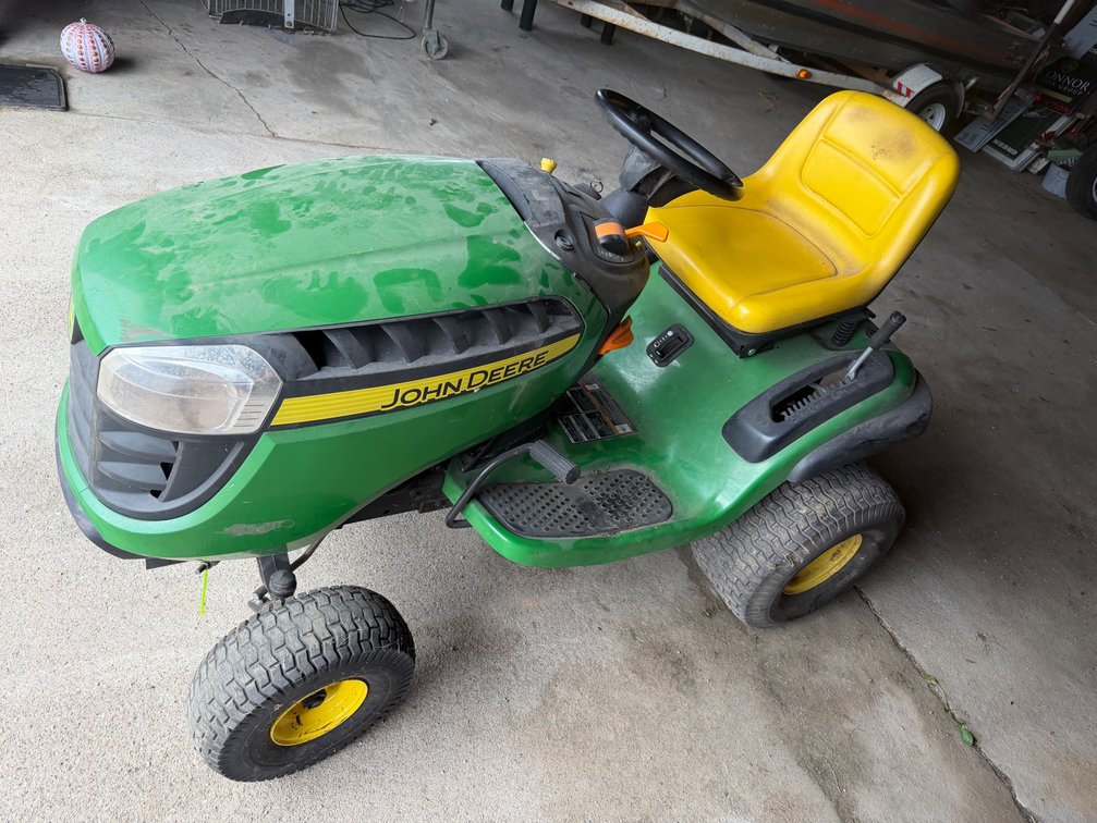 John Deere D140, No Deck, Steers Hard, Runs, Needs Battery, Cable is broke that runs deck.