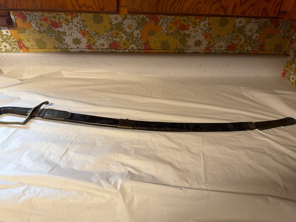 Antique Curved Saber With a Brass Hilt