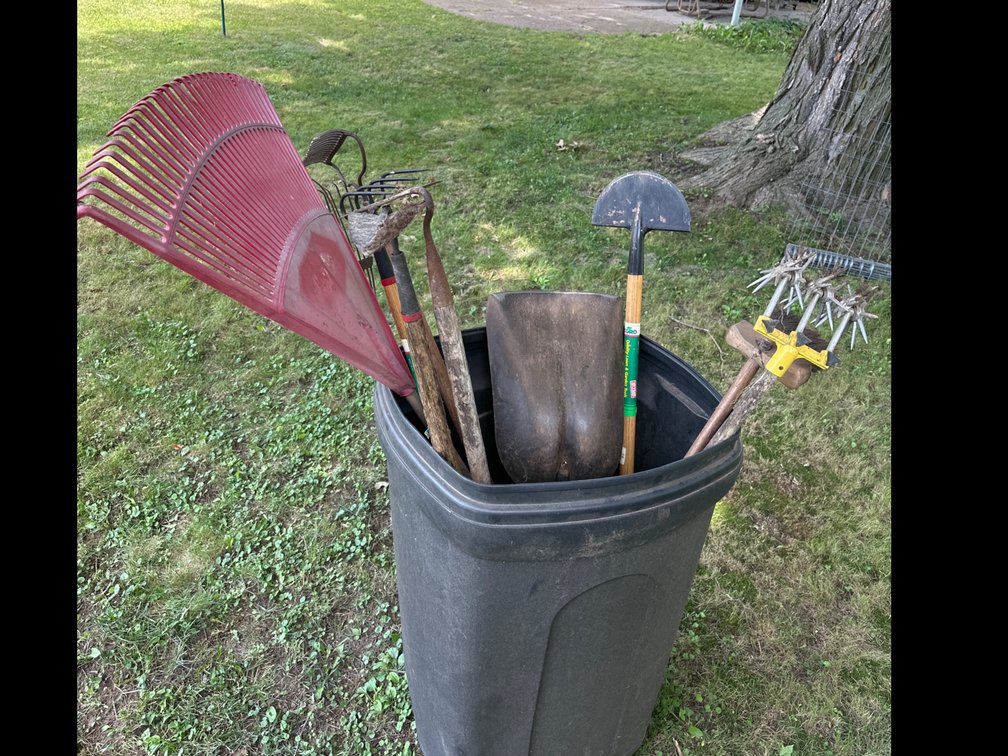 Garbage Can with Lawn and Garden Tools