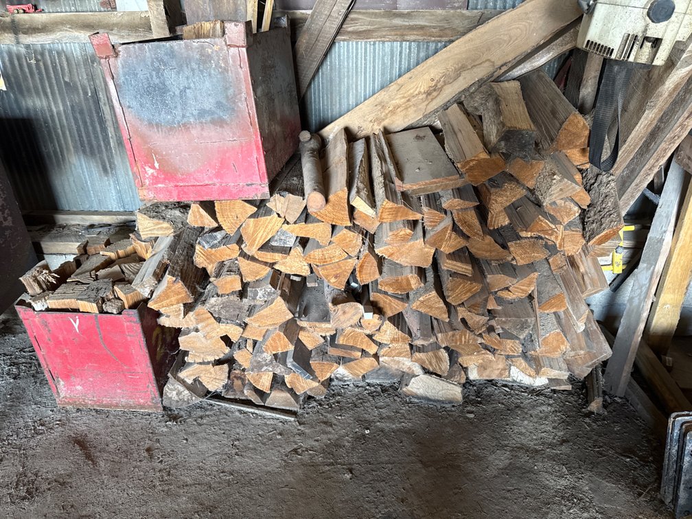 Firewood and Red Metal Containers with Wood