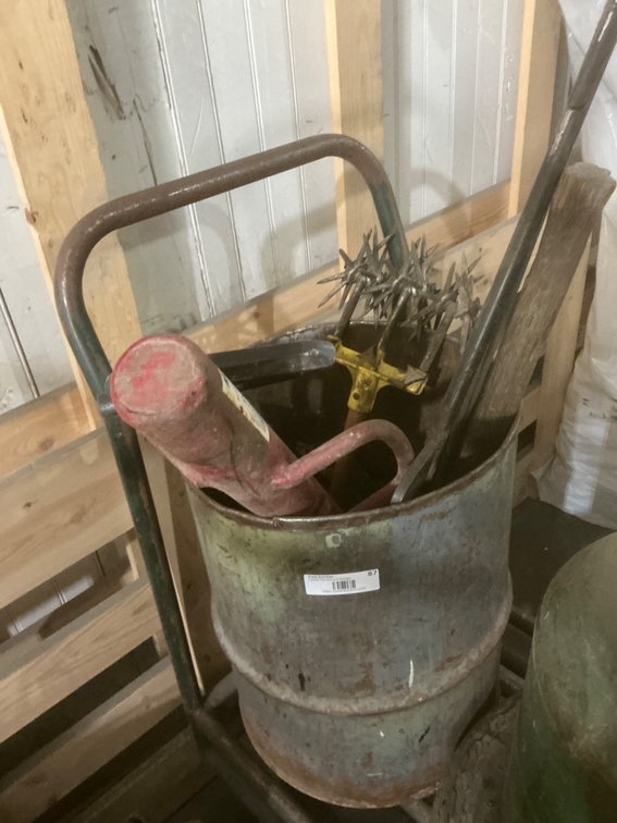 Small Metal Barrel Containing Manual Post Pounder, Hanging Gambrel, Garden Tiller/Aerator Hand Tool (Broken Handle), (2) Bike Tire Hand Pumps, Wilmar 1-Ton Chain Hoist and Other Miscellaneous