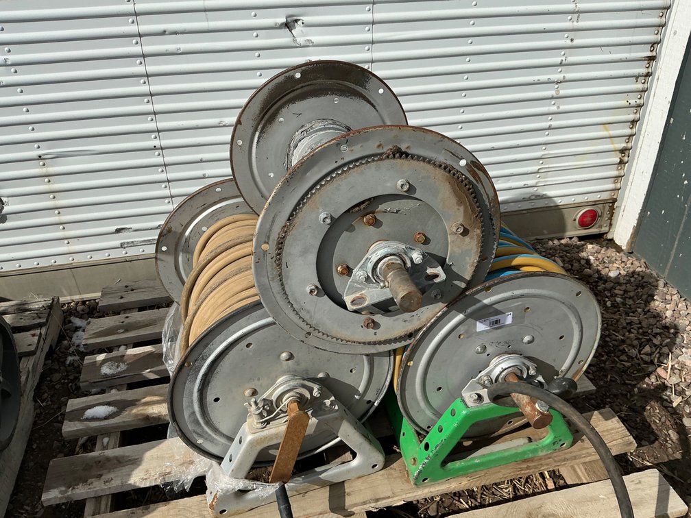 (3) Assorted Hose Reels - One Has Frame, Electric Motor and Weathered Hose, One Has The Frame, and One Is Just A Reel