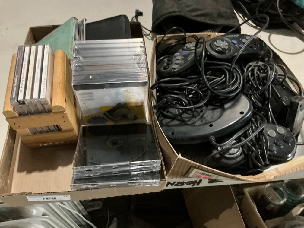 Assorted CD's, CD Jewel Cases and Sega Genesis Gaming Console with Assorted Controllers