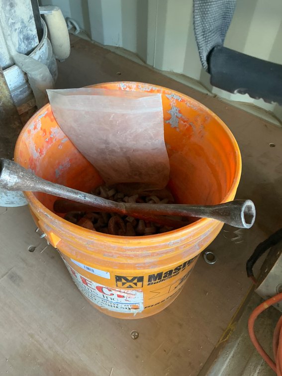 Partial Bucket of Assorted Cable Clamps and T-Bar Lug Wrench