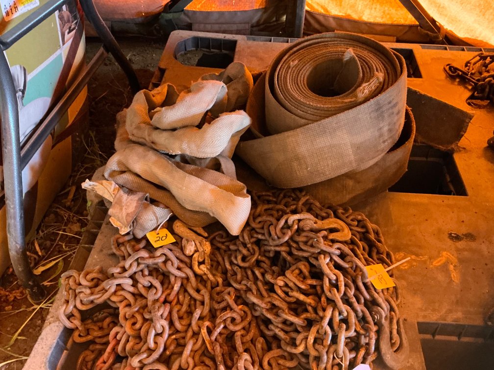 (1) Small Fence Pulling Chain, (1) 35'L Section Of Chain With Hooks On Both Ends, (1) 20'L Thin Chain With Hooks On Both Ends, (1) Lifting Sling (Frayed), And (2) Load Straps (Frayed)