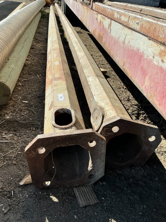 (2) Steel Streetlight Poles - One Is 27'L And One Is 25'L, With 12" Bases Tapered Up To 3-1/2" Tops