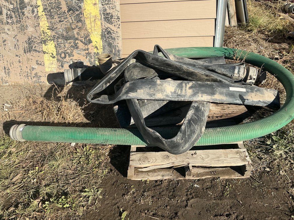 (1) 6" Goodyear Flat Rubber Hose - Coupler On One End, (1) 6'L Section Of 4" Black Hard Suction Hose - Couplers On Both Ends, And (1) Approximately 12'L Section Of Green Hard Suction Hose With Couplers On Both Ends