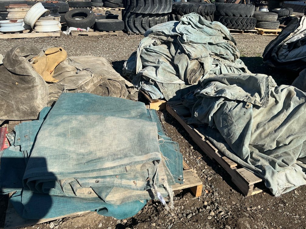(3) Pallets Of Assorted Canvas Tarps, Some Have Insulated Pads Within (Weathered), And (1) Pallet Of Woven Shade Cloth/Privacy Screen (Weathered)