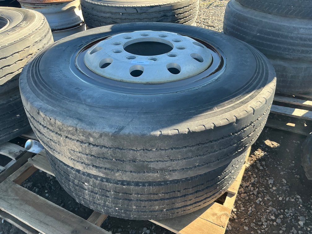 (2) 10.00R22 Tires On 10-Lug Wheels (One Wheels Is Aluminum, One Steel) - Fair Tread