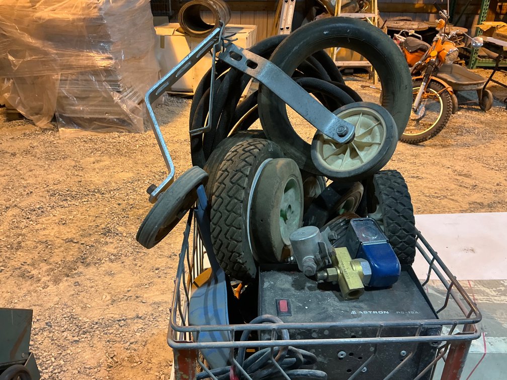 Metal Crate Containing - (12) Assorted Push Mower/Trimmer Wheels, (1) Astron RS-12A Linear Power Suppy, (1) Solenoid Valve, (1) Solenoid, And (1) Hydraulic Hose
