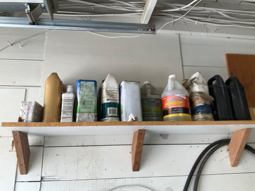 Shelf of Assorted Shop Lubricants and More - See Description for Details