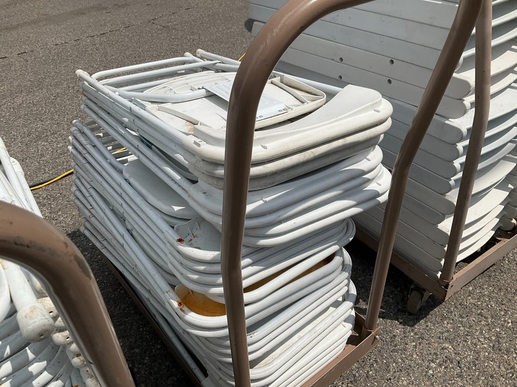 Rolling Cart with Approximately (24) Metal Frame White Plastic Folding Chairs