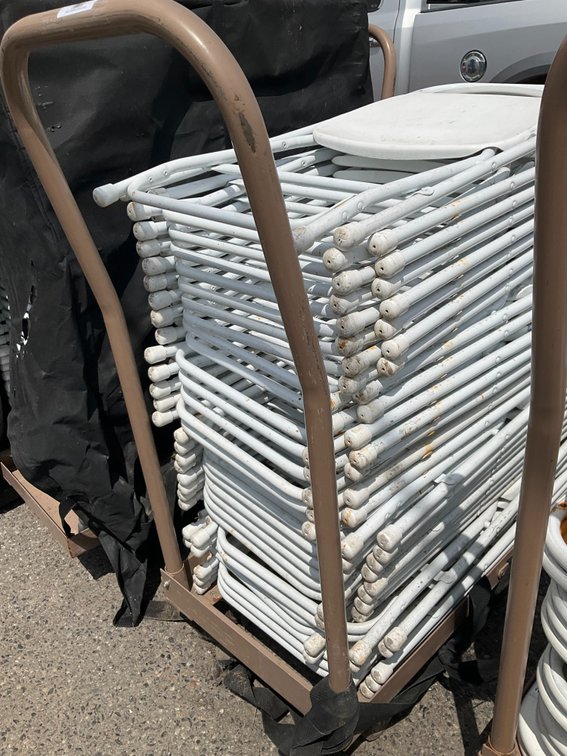 Rolling Cart with Approximately (28) Metal Frame White Plastic Folding Chairs
