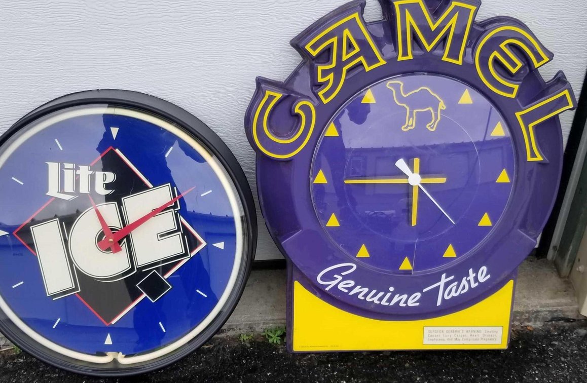 Two advertising clocks, one neon