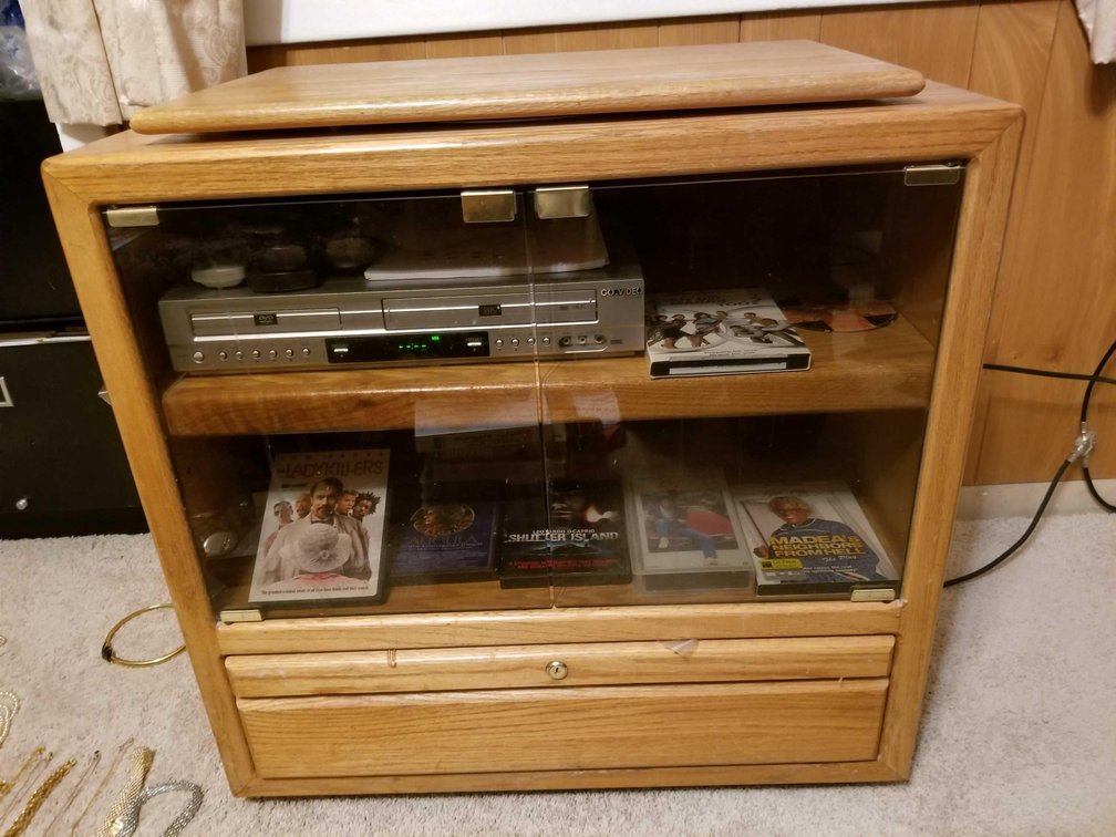 Solid wood entertainment console with DVD/VCR player and assorted contents 