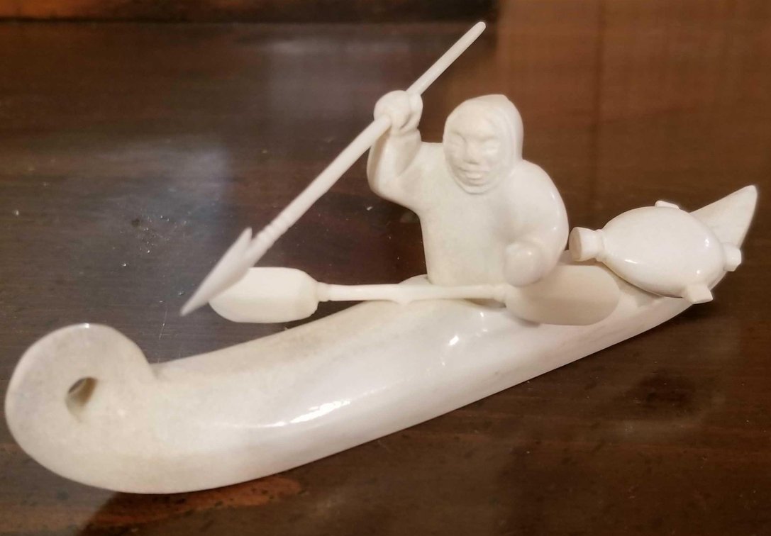 Russian carved and polished bone kayak hunter 